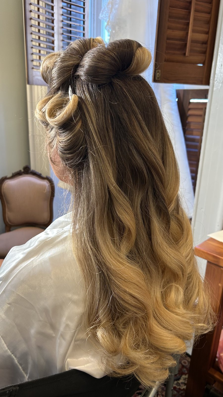Elaborate bridal half-up with hair bow detail.