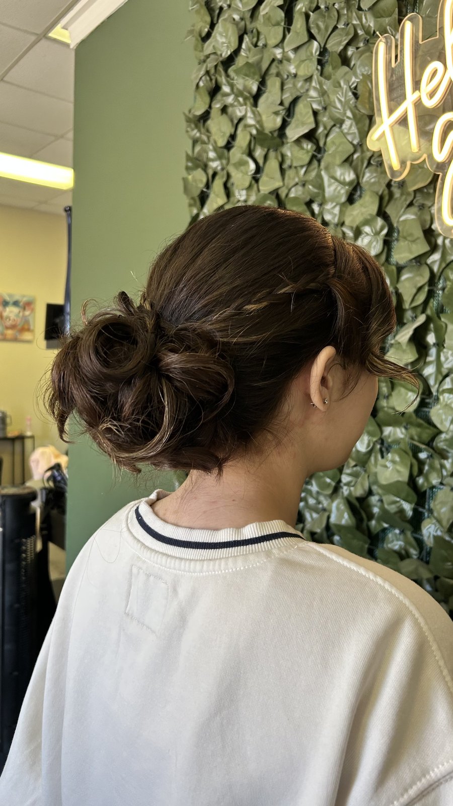 Textured low bun, salon interior.